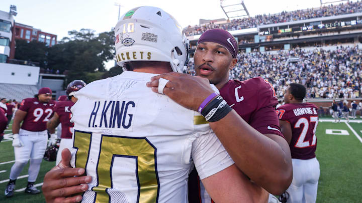 Oct 11, 2025; Atlanta, Georgia, USA; Georgia Tech Yellow Jackets quarterback Haynes King (10) talks to Virginia Tech Hokies quarterback Kyron Drones (1) after a game at Bobby Dodd Stadium at Hyundai Field. Mandatory Credit: Brett Davis-Imagn Images
