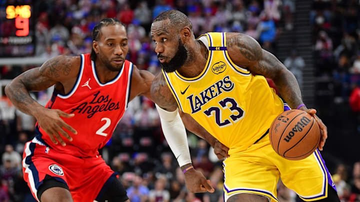 Feb 4, 2025; Inglewood, California, USA; Los Angeles Lakers forward LeBron James (23) moves the ball against Los Angeles Clippers forward Kawhi Leonard (2) during the second half at Intuit Dome. Mandatory Credit: Gary A. Vasquez-Imagn Images