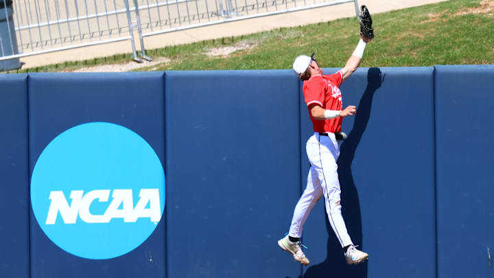 May 30, 2025; Oxford, MS, USA;  Western Kentucky Hilltoppers outfielder Ryan Wideman (33) attempts to save a three home run hit by Georgia Tech Yellowjackets pitcher/infielder Alex Hernandez (4) during the first inning. Mandatory Credit: Petre Thomas-Imagn Images