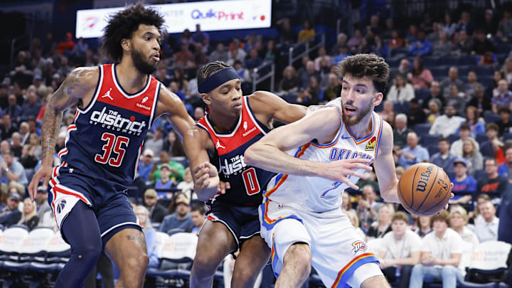 Feb 23, 2024; Oklahoma City, Oklahoma, USA; Oklahoma City Thunder forward Chet Holmgren (7) is defended by Washington Wizards forward Marvin Bagley III (35) and guard Bilal Coulibaly (0) on a drive during the second half at Paycom Center. Mandatory Credit: Alonzo Adams-Imagn Images