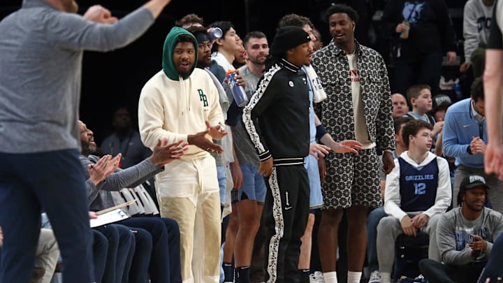 Mar 2, 2024; Memphis, Tennessee, USA; Memphis Grizzlies guard Marcus Smart (left), guard Ja Morant (middle) and forward-center Jaren Jackson Jr. (right) react from the bench during the first half against the Portland Trail Blazers at FedExForum. Mandatory Credit: Petre Thomas-Imagn Images