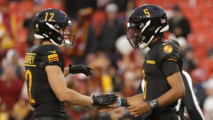 Dec 1, 2024; Landover, Maryland, USA; Washington Commanders quarterback Jayden Daniels (5) celebrates with Commanders wide receiver Luke McCaffrey (12) after defeating the Tennessee Titans at Northwest Stadium. Mandatory Credit: Amber Searls-Imagn Images