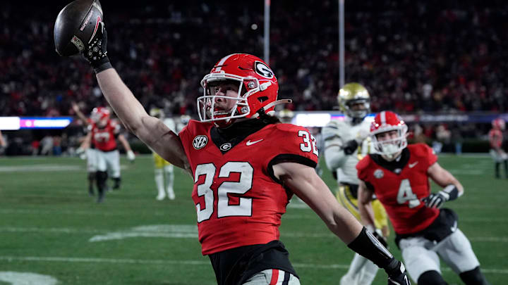 Georgia running back Cash Jones (32) scores during overtime of a NCAA college football game against Georgia Tech in Athens, Ga., on Friday, Nov. 29, 2024.