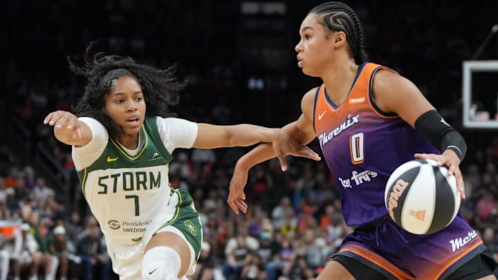 Jun 7, 2025; Phoenix, Arizona, USA; Phoenix Mercury forward Satou Sabally (0) drives on Seattle Storm guard Zia Cooke (7) in the second half at Footprint Center. Mandatory Credit: Rick Scuteri-Imagn Images