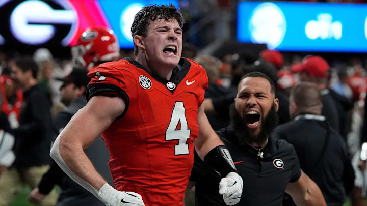 Georgia tight end Oscar Delp (4) celebrates after Georgia won in overtime of the SEC championship game against Texas in Atlanta, on Saturday, Dec. 7, 2024. Georgia won 22-19.