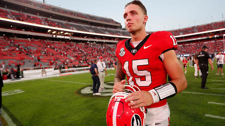 Georgia quarterback Carson Beck (15) leaves the field after winning a game against Auburn.