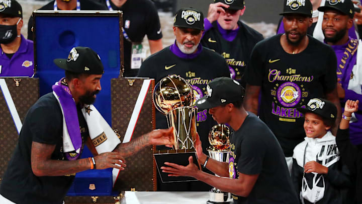 Oct 11, 2020; Lake Buena Vista, Florida, USA; Los Angeles Lakers guard JR Smith (21) and guard Rajon Rondo (9) hold the trophy after game six of the 2020 NBA Finals at AdventHealth Arena. The Los Angeles Lakers won 106-93 to win the series. Mandatory Credit: Kim Klement-Imagn Images
