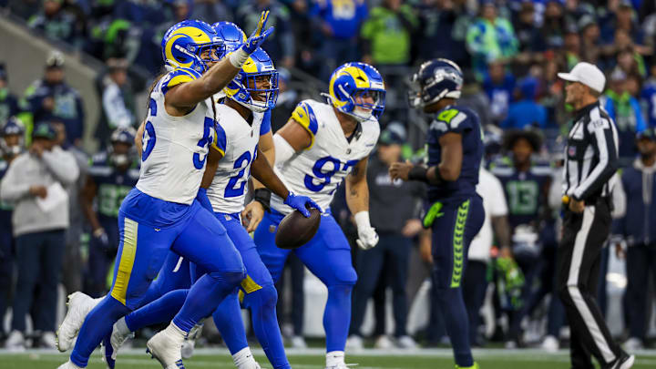 Nov 3, 2024; Seattle, Washington, USA; Los Angeles Rams safety Kamren Kinchens (26) celebrates following an interception against Seattle Seahawks quarterback Geno Smith (7, background second from right) during the fourth quarter at Lumen Field. Mandatory Credit: Joe Nicholson-Imagn Images Nov 3, 2024; Seattle, Washington, USA; Los Angeles Rams safety Kamren Kinchens (26) celebrates following an interception against Seattle Seahawks quarterback Geno Smith (7, background second from right) during the fourth quarter at Lumen Field. Mandatory Credit: Joe Nicholson-Imagn Images