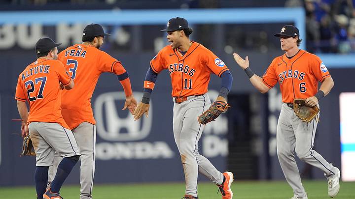 Houston Astros right fielder Cam Smith (11) and shortstop Jeremy Pena (3) and  second baseman Jose Altuve (27) and left fielder Jake Meyers (6) celebrate a win over the Toronto Blue Jays.