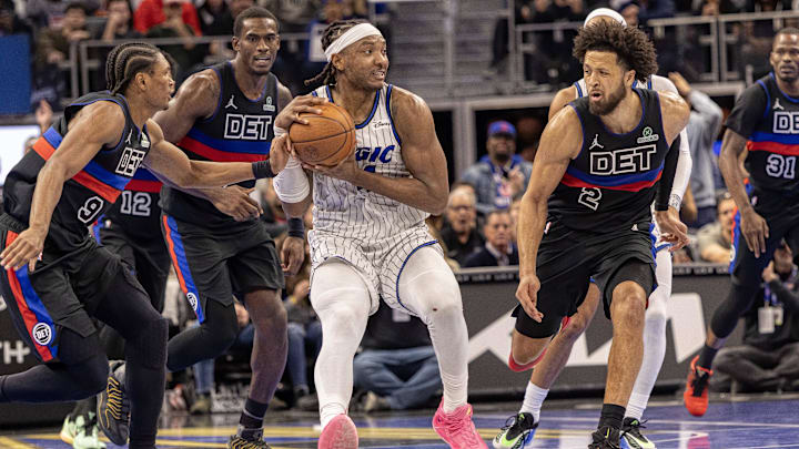 Nov 28, 2025; Detroit, Michigan, USA; Orlando Magic center Wendell
Carter Jr. (34) hangs on to the ball between Detroit Pistons guard Ausar Thompson (9) and guard Cade Cunningham (2) in the second half of the annual in-season NBA Cup tournament at Little Caesars Arena. Mandatory Credit: David Reginek-Imagn Images