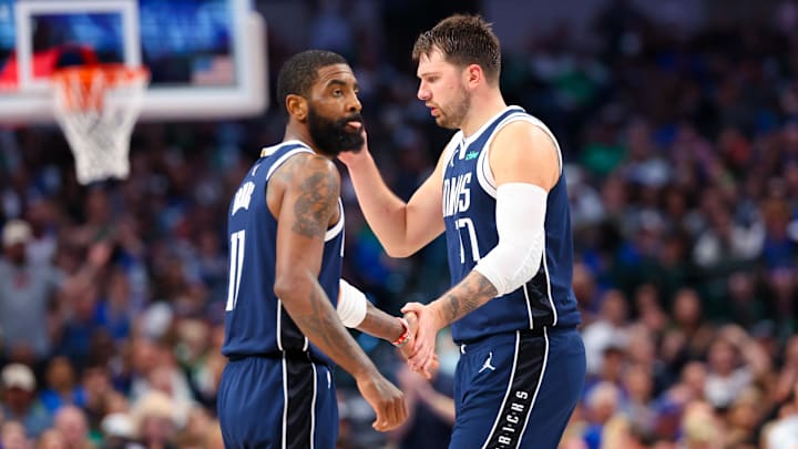 Dallas Mavericks guard Kyrie Irving (11) celebrates with Dallas Mavericks guard Luka Doncic.
