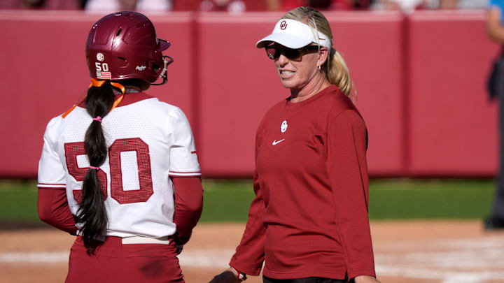 Oklahoma coach Patty Gasso speaks with second baseman Ailana Agbayani.