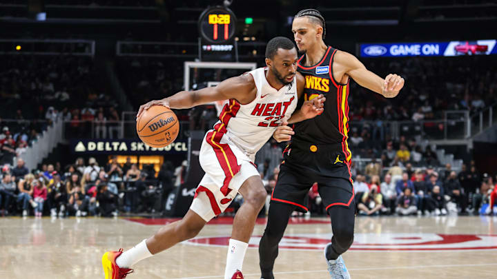 Dec 26, 2025; Atlanta, Georgia, USA; Miami Heat forward Andrew Wiggins (22) drives the ball towards the goal against Atlanta Hawks forward Zaccharie Risacher (10) during the first quarter at State Farm Arena. Mandatory Credit: Jordan Godfree-Imagn Images