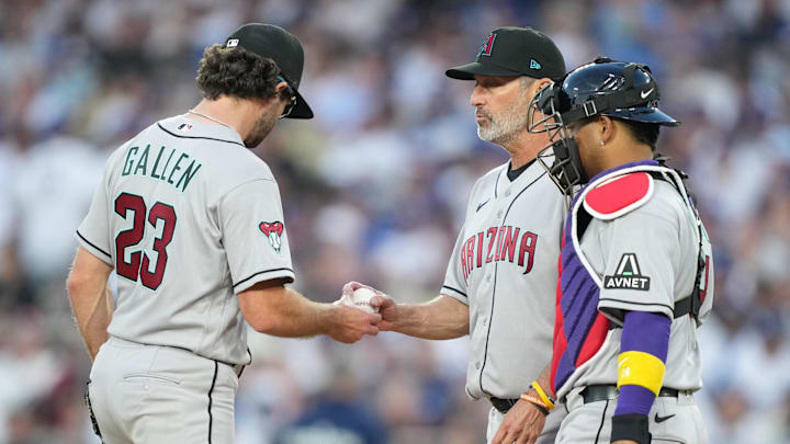 Mar 26, 2026; Los Angeles, California, USA; Arizona Diamondbacks starting pitcher Zac Gallen (23) hands the ball to manager Torey Lovullo (17) during a pitching change as infielder Carlos Santana (41) and catcher Gabriel Moreno (14) look on against the Arizona Diamondbacks during the fifth inning at Dodger Stadium. Mandatory Credit: Kirby Lee-Imagn Images Mar 26, 2026; Los Angeles, California, USA; Arizona Diamondbacks starting pitcher Zac Gallen (23) hands the ball to manager Torey Lovullo (17) during a pitching change as infielder Carlos Santana (41) and catcher Gabriel Moreno (14) look on against the Arizona Diamondbacks during the fifth inning at Dodger Stadium. Mandatory Credit: Kirby Lee-Imagn Images