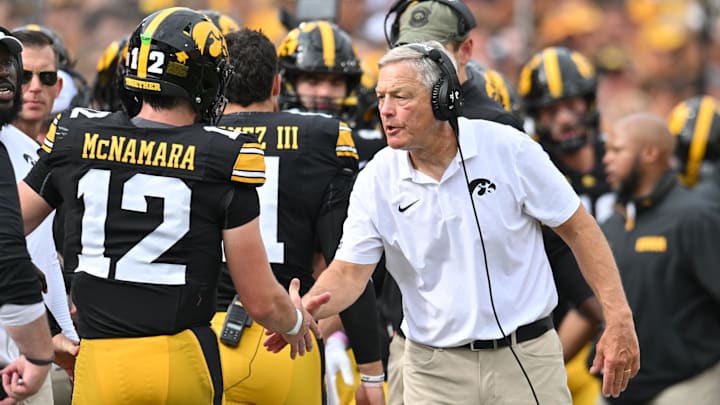 Sep 14, 2024; Iowa City, Iowa, USA; Iowa Hawkeyes head coach Kirk Ferentz reacts with quarterback Cade McNamara (12) after a touchdown against the Troy Trojans during the second quarter at Kinnick Stadium. Mandatory Credit: Jeffrey Becker-Imagn Images