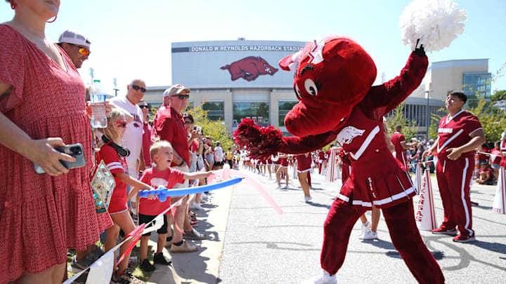 Sep 9, 2023; Fayetteville, Arkansas, USA;  Arkansas Razorbacks mascot entertains fans during the  Hog Walk  prior to the game against the Kent State Golden Flashes at Donald W. Reynolds Razorback Stadium. Mandatory Credit: Nelson Chenault-Imagn Images