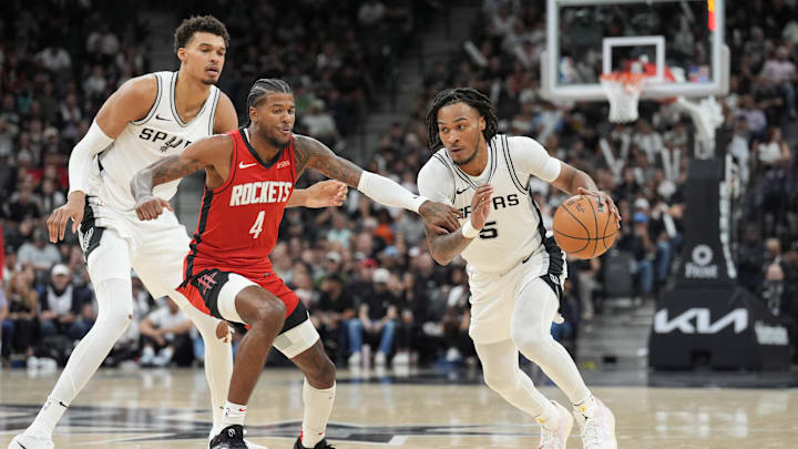 Oct 26, 2024; San Antonio, Texas, USA; San Antonio Spurs guard Stephon Castle (5) dribbles past Houston Rockets guard Jalen Green (4) in the second half at Frost Bank Center.