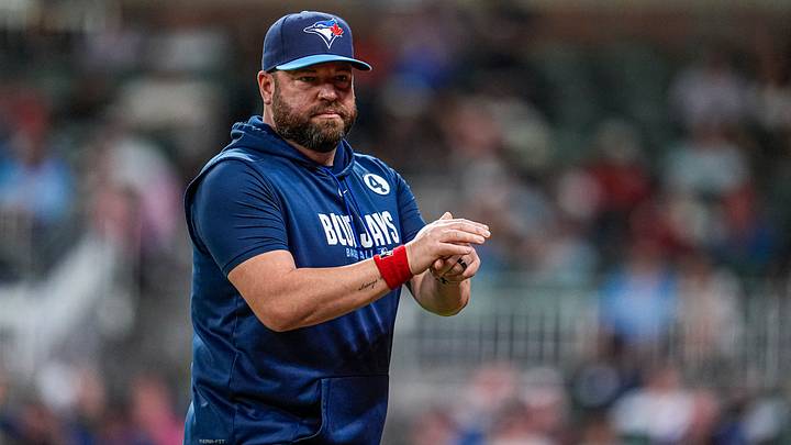 Blue Jays manager John Schneider (14) on the field against the Atlanta Braves during the eighth inning at Truist Park Blue Jays manager John Schneider (14) on the field against the Atlanta Braves during the eighth inning at Truist Park
