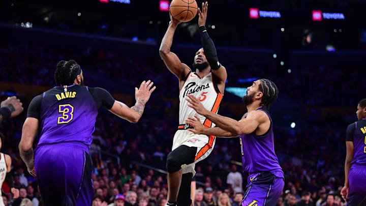 Dec 23, 2024; Los Angeles, California, USA; Detroit Pistons guard Malik Beasley (5) shoots against Los Angeles Lakers forward Anthony Davis (3) and guard Gabe Vincent (7) during the first half at Crypto.com Arena. Mandatory Credit: Gary A. Vasquez-Imagn Images