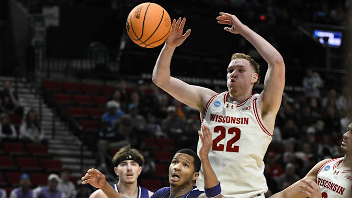 Mar 19, 2026; Portland, OR, USA; High Point Panthers guard Rob Martin (3) and Wisconsin Badgers forward Austin Rapp (22) go after a loose ball during the first half of a first round game of the men's 2026 NCAA Tournament at Moda Center. Mandatory Credit: Troy Wayrynen-Imagn Images