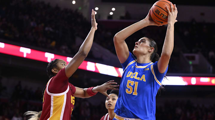 Feb 13, 2025; Los Angeles, California, USA; UCLA Bruins center Lauren Betts (51) shoots over USC Trojans guard Aaliyah Gayles (3) during the first quarter at Galen Center. Mandatory Credit: Robert Hanashiro-Imagn Images