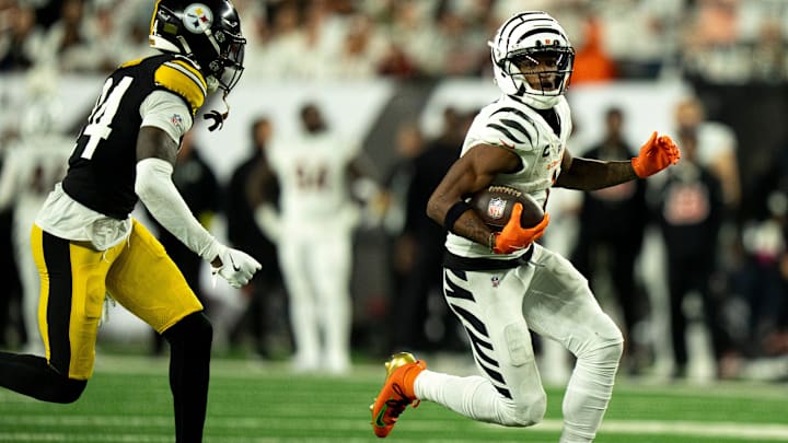 Cincinnati Bengals wide receiver Ja'Marr Chase (1) runs downfield as Pittsburgh Steelers cornerback Joey Porter Jr. (24) goes to tackle him in the third quarter of the NFL game between the Cincinnati Bengals and Pittsburgh Steelers at Paycor Stadium in Cincinnati on Oct. 16, 2025.