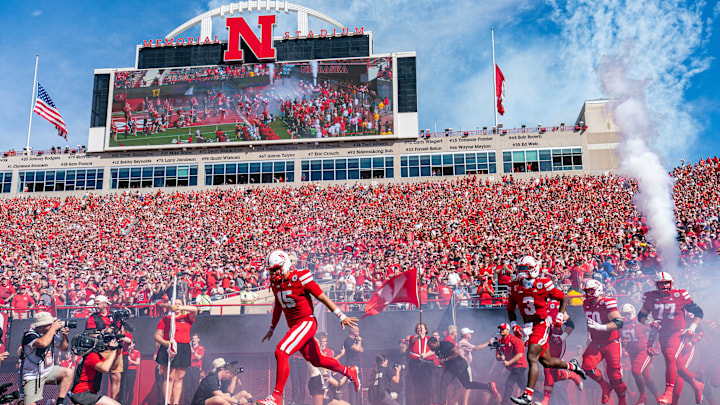 The Nebraska Cornhuskers run onto the field before the game against the Houston Christian Huskies at Memorial Stadium.