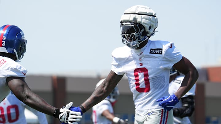 Jul 26, 2024; East Rutherford, NJ, USA; New York Giants linebacker Brian Burns (0) high fives New York Giants defensive tackle Rakeem Nunez-Roches (93) during training camp at Quest Diagnostics Training Center. Mandatory Credit: Lucas Boland-USA TODAY Sports