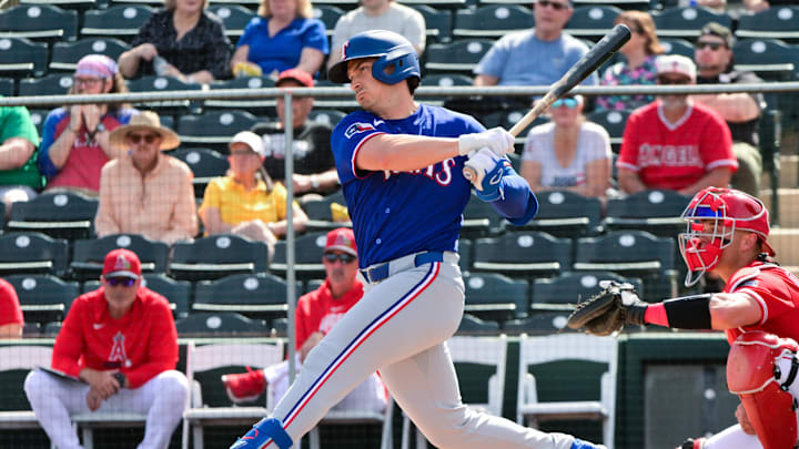 Feb 23, 2026; Tempe, Arizona, USA; Texas Rangers first baseman Justin Foscue (56) singles in the first inning against the Los Angeles Angels during a spring training game at Tempe Diablo Stadium. Mandatory Credit: Matt Kartozian-Imagn Images Feb 23, 2026; Tempe, Arizona, USA; Texas Rangers first baseman Justin Foscue (56) singles in the first inning against the Los Angeles Angels during a spring training game at Tempe Diablo Stadium. Mandatory Credit: Matt Kartozian-Imagn Images