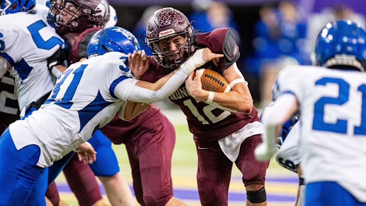 Grundy Center's Judd Jirovsky (12) runs the ball up the middle on Thursday, Nov. 21, 2024, at the UNI-Dome in Cedar Falls, IA.