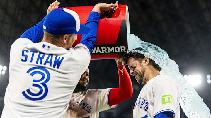 Mar 28, 2026: Toronto Blue Jays first baseman Vladimir Guerrero Jr. (27) and center fielder Myles Straw (3) pour a sports drink on third baseman Ernie Clement (22) after defeating the Athletics at Rogers Centre. 