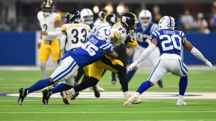 Sep 29, 2024; Indianapolis, Indiana, USA; Pittsburgh Steelers tight end Pat Freiermuth (88) is tackled by Indianapolis Colts linebacker E.J. Speed (45) during the first quarter at Lucas Oil Stadium. Mandatory Credit: Marc Lebryk-Imagn Images