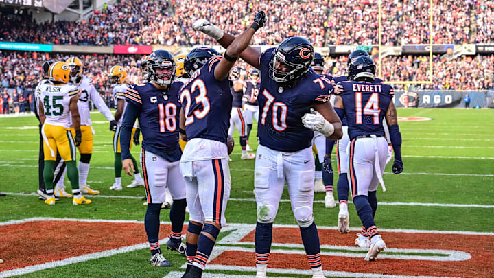 Nov 17, 2024; Chicago, Illinois, USA; Chicago Bears running back Roschon Johnson (23) celebrates his rushing touchdown with offensive tackle Braxton Jones (70) against the Green Bay Packers during the second quarter at Soldier Field. Mandatory Credit: Daniel Bartel-Imagn Images