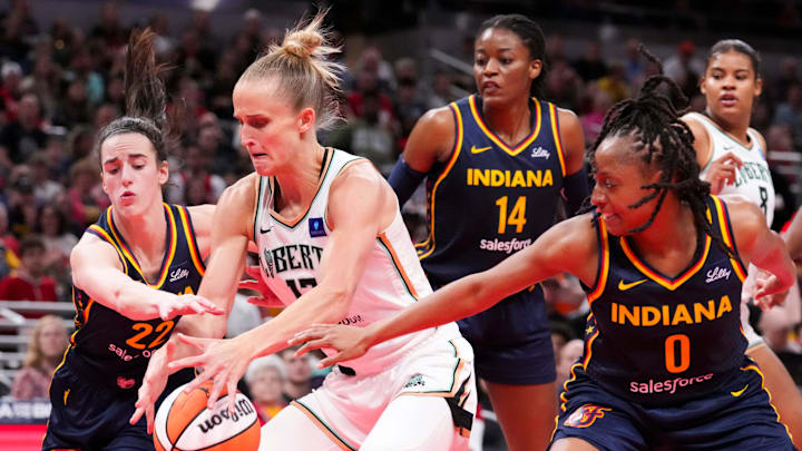 Indiana Fever guard Caitlin Clark (22) and Indiana Fever guard Kelsey Mitchell (0) defend New York Liberty guard Courtney Vandersloot (22) on Thursday, May 16, 2024, during the Indiana Fever home opener game against the New York Liberty at Gainbridge Fieldhouse in Indianapolis. Indiana Fever guard Caitlin Clark (22) and Indiana Fever guard Kelsey Mitchell (0) defend New York Liberty guard Courtney Vandersloot (22) on Thursday, May 16, 2024, during the Indiana Fever home opener game against the New York Liberty at Gainbridge Fieldhouse in Indianapolis.