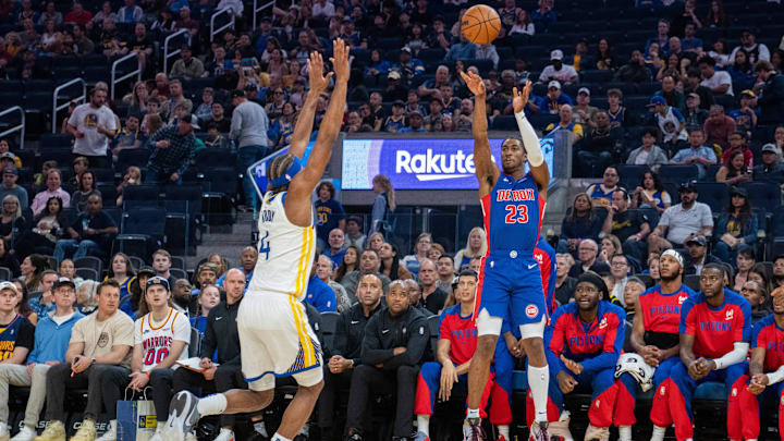 Oct 13, 2024; San Francisco, California, USA;  Detroit Pistons guard Jaden Ivey (23) shoots a three point basket over Golden State Warriors guard Moses Moody (4) during the first quarter at Chase Center. Mandatory Credit: Neville E. Guard-Imagn Images