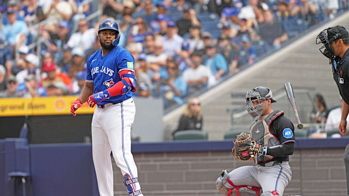 Sep 29, 2024; Toronto, Ontario, CAN; Toronto Blue Jays designated hitter Vladimir Guerrero Jr. (27) flips his bat after being walked against the Miami Marlins during the first inning at Rogers Centre. Sep 29, 2024; Toronto, Ontario, CAN; Toronto Blue Jays designated hitter Vladimir Guerrero Jr. (27) flips his bat after being walked against the Miami Marlins during the first inning at Rogers Centre.