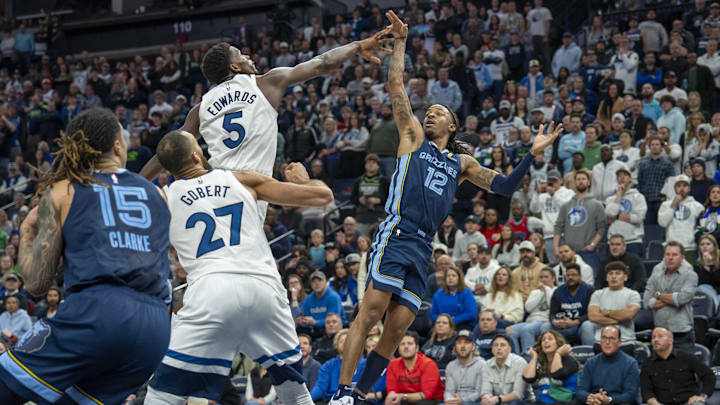 Memphis Grizzlies guard Ja Morant falls back after releasing the game-winning shot over Minnesota Timberwolves guard Anthony Edwards (5) in the second half at Target Center in Minneapolis on Jan. 11, 2025.