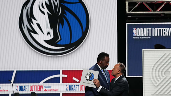 Rolando Blackman of the Dallas Mavericks reacts with Mark Tatum NBA Deputy Commissioner after winning the the first pick during the 2025 NBA Draft Lottery.