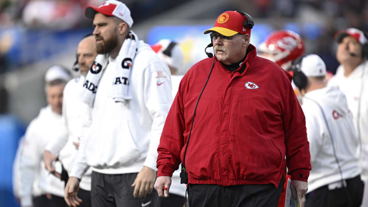 Jan 7, 2024; Inglewood, California, USA; Kansas City Chiefs head coach Andy Reid (front, right) looks on ahead of tight end Travis Kelce (left) during the first half against the Los Angeles Chargers at SoFi Stadium. Mandatory Credit: Orlando Ramirez-USA TODAY Sports