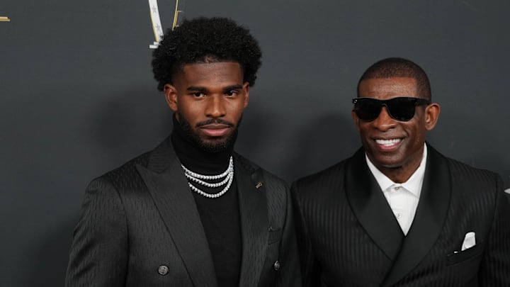 Deion Sanders (with his son Shedeur Sanders on the red carpet before Super Bowl LIX NFL Honors.