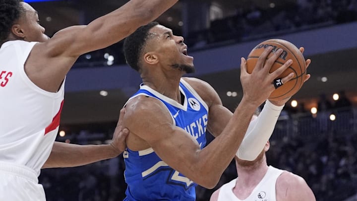 Jan 17, 2025; Milwaukee, Wisconsin, USA; Milwaukee Bucks forward Giannis Antetokounmpo (34) drives to the basket against Toronto Raptors center Jakob Poeltl (19) in the second half at Fiserv Forum. Mandatory Credit: Michael McLoone-Imagn Images