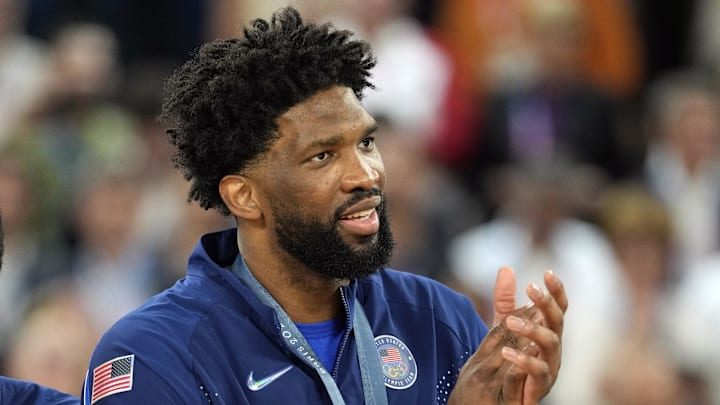 Aug 10, 2024; Paris, France; United States centre Joel Embiid (11) celebrates with the gold medal after the game against France in the men's basketball gold medal game during the Paris 2024 Olympic Summer Games at Accor Arena. Mandatory Credit: Kyle Terada-Imagn Images