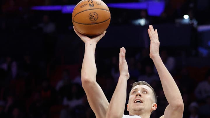 Nov 29, 2025; Miami, Florida, USA;  Detroit Pistons forward Duncan Robinson (55) shoots the ball against Miami Heat guard Tyler Herro (14) during the second half at Kaseya Center. Mandatory Credit: Rhona Wise-Imagn Images