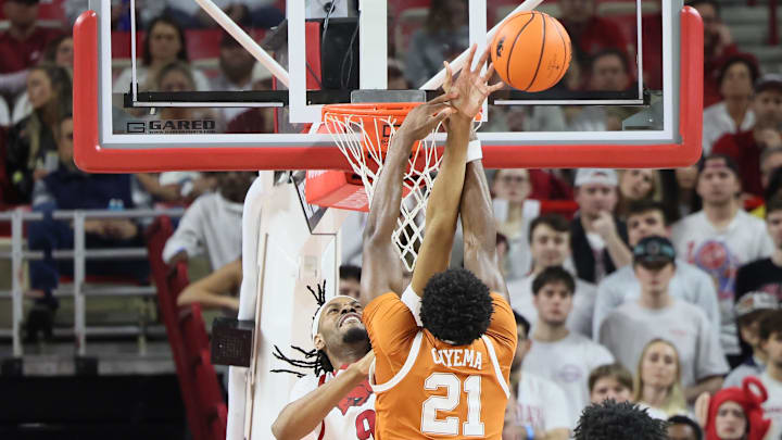 Feb 26, 2025; Fayetteville, Arkansas, USA; Arkansas Razorbacks forward Jonas Aidoo (9) blocks a shot attempt by Texas Longhorns forward Ze’Rik Onyema (21) during the first half at Bud Walton Arena. Mandatory Credit: Nelson Chenault-Imagn Images