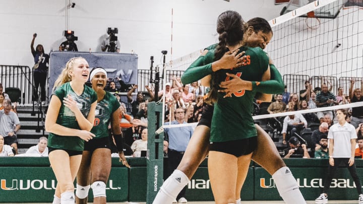 Miami Hurricanes Volleyball embracing after securing a victory 