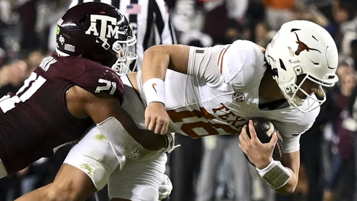 Nov 30, 2024; College Station, Texas, USA; Texas A&M Aggies linebacker Taurean York (21) tackles Texas Longhorns quarterback Arch Manning (16) during the second half. The Longhorns defeated the Aggies 17-7 at Kyle Field. Mandatory Credit: Maria Lysaker-Imagn Images Nov 30, 2024; College Station, Texas, USA; Texas A&M Aggies linebacker Taurean York (21) tackles Texas Longhorns quarterback Arch Manning (16) during the second half. The Longhorns defeated the Aggies 17-7 at Kyle Field. Mandatory Credit: Maria Lysaker-Imagn Images