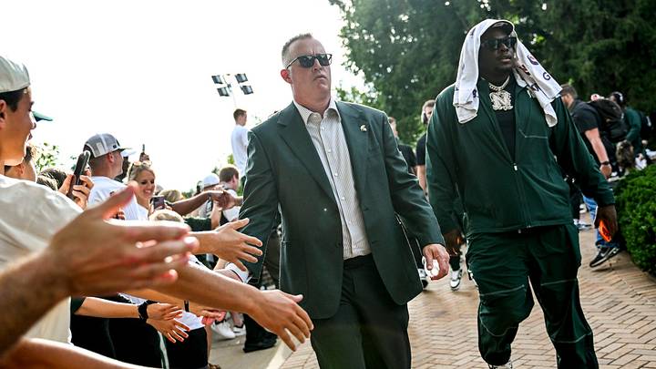 Michigan State’s head coach Pat Fitzgerald, left, and Nick Sharpe lead the team walk to the stadium before the football game against Toledo on Friday, Sept. 4, 2026, at in East Lansing. Michigan State’s head coach Pat Fitzgerald, left, and Nick Sharpe lead the team walk to the stadium before the football game against Toledo on Friday, Sept. 4, 2026, at in East Lansing.