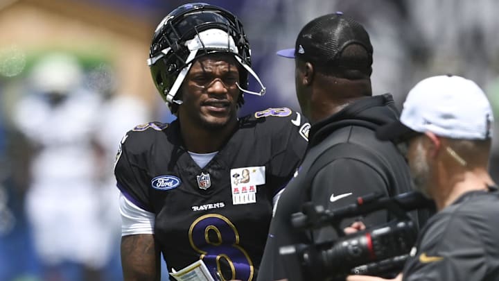 Jul 27, 2024; Owings Mill , MD, USA; Baltimore Ravens quarterback Lamar Jackson  speaks with quarterback coach Tee Martin during the afternoon session of training camp at the Under Armour Performance Center,  Mandatory Credit: Tommy Gilligan-Imagn Images