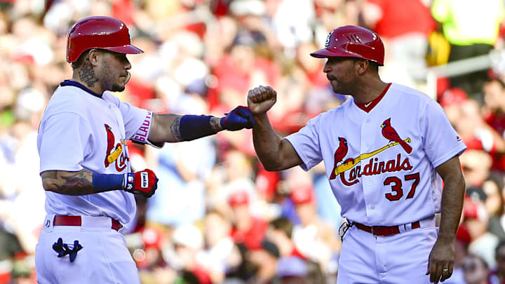 May 30, 2017; St. Louis, MO, USA; St. Louis Cardinals catcher Yadier Molina (4) celebrates with first base coach Oliver Marmol (37) after hitting a two run single off of Los Angeles Dodgers starting pitcher Kenta Maeda (not pictured) during the first inning at Busch Stadium. Mandatory Credit: Jeff Curry-Imagn Images