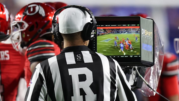 Oct 18, 2025; Provo, Utah, USA; Referee Henry Johns reviews a targeting call during the game between the Utah Utes and the BYU Cougars at LaVell Edwards Stadium. Mandatory Credit: Rob Gray-Imagn Images